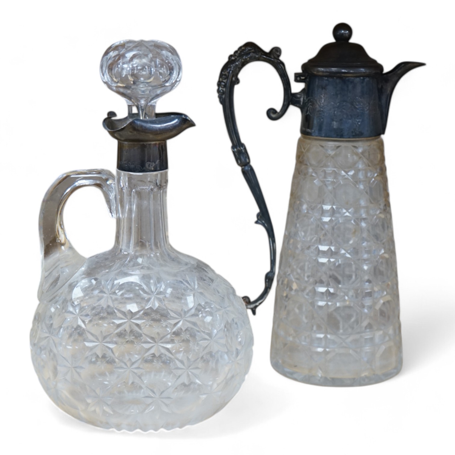 An Edwardian silver mounted cut glass decanter and stopper, London, 1901, height 26cm, together with a silver plate mounted cut glass claret jug. Condition - poor to fair